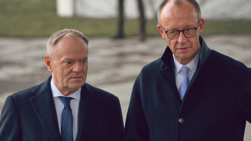 Tusk und Merz stehen nebeneinander